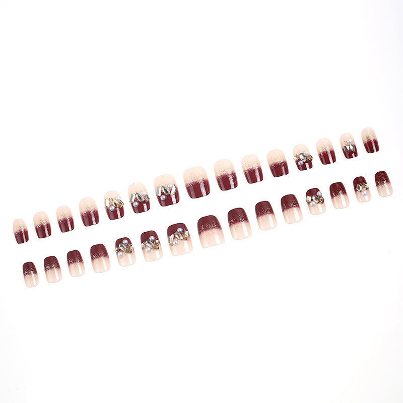 Glamorous artificial nails with decorative pearl and glitter embellishments Acalora