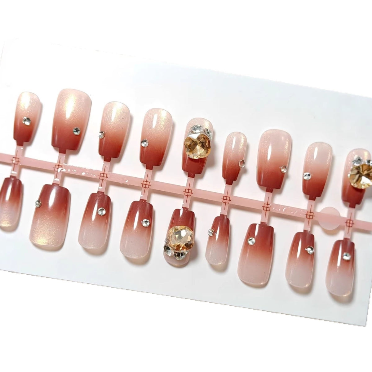 Artificials nails in elegant ombre style with rhinestone embellished applications Acalora