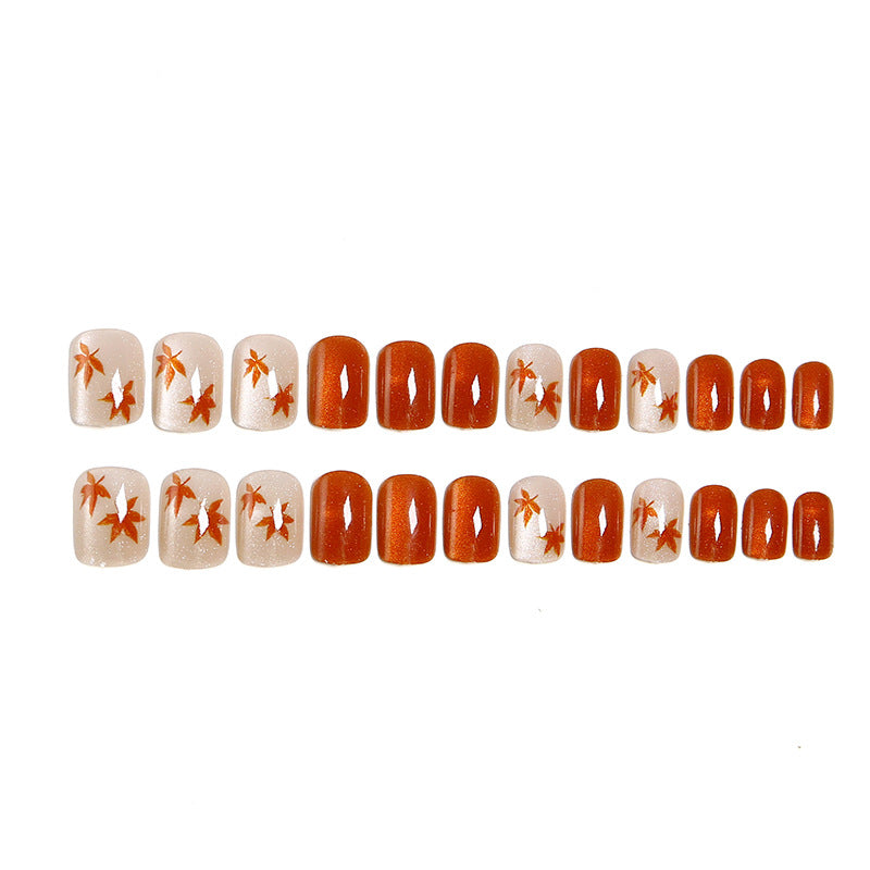 Artificial nails with glamorous ombre design and autumn leaf applications Acalora