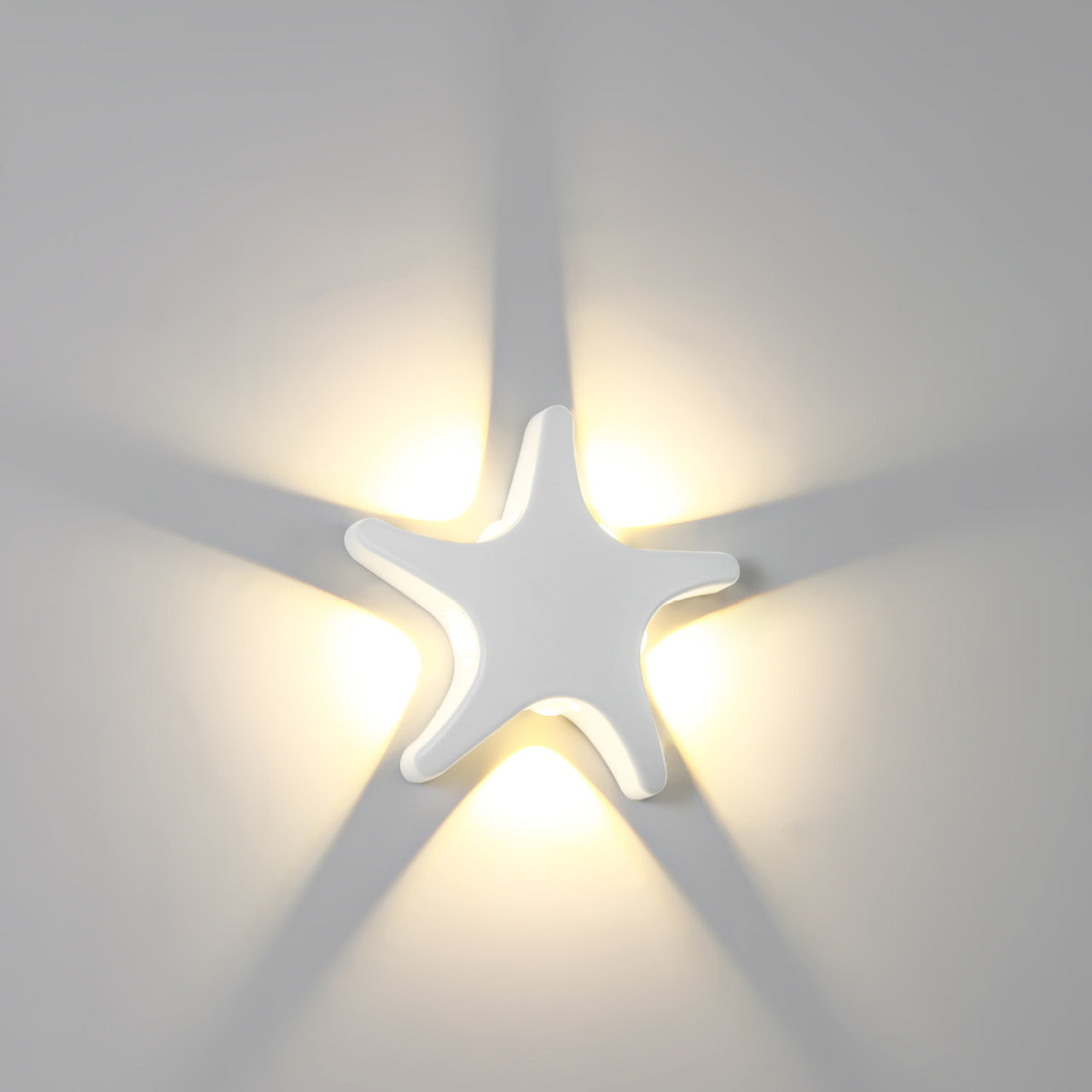 Modern, simple LED wall light made of aluminum in starfish design, waterproof, for the patio
