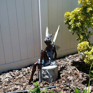 Statue of a sitting fairy in the garden