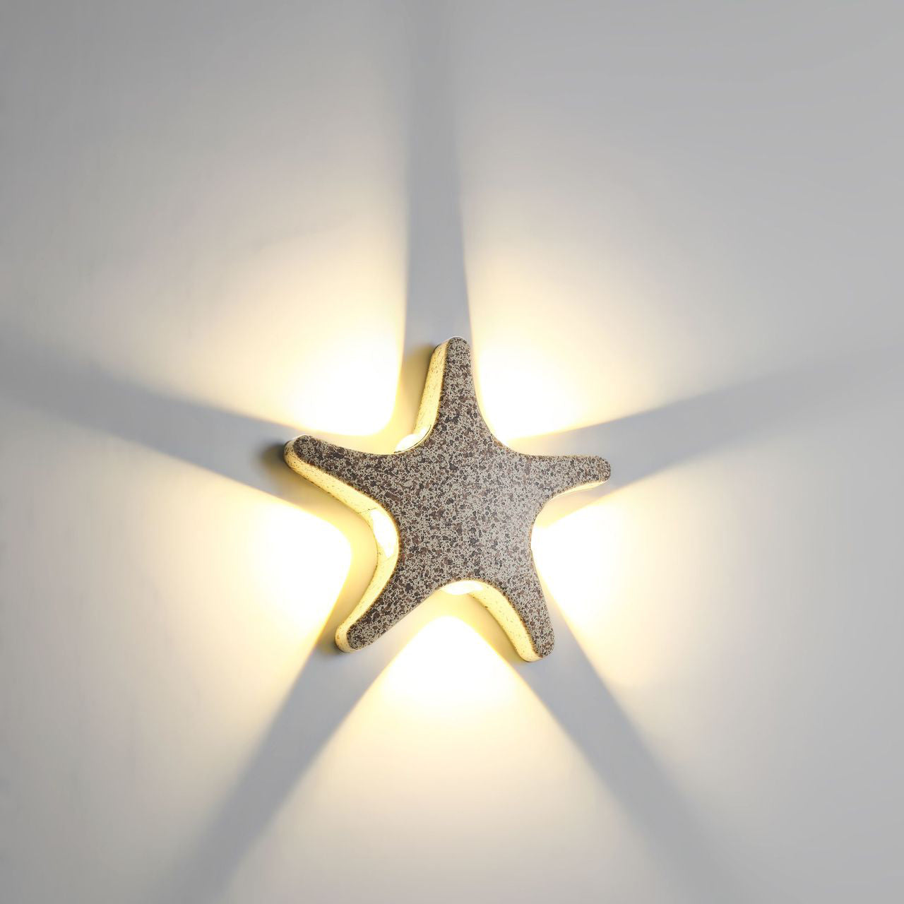 Modern, simple LED wall light made of aluminum in starfish design, waterproof, for the patio
