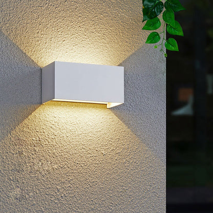 Modern, waterproof, rectangular outdoor LED wall light with up and down lighting.