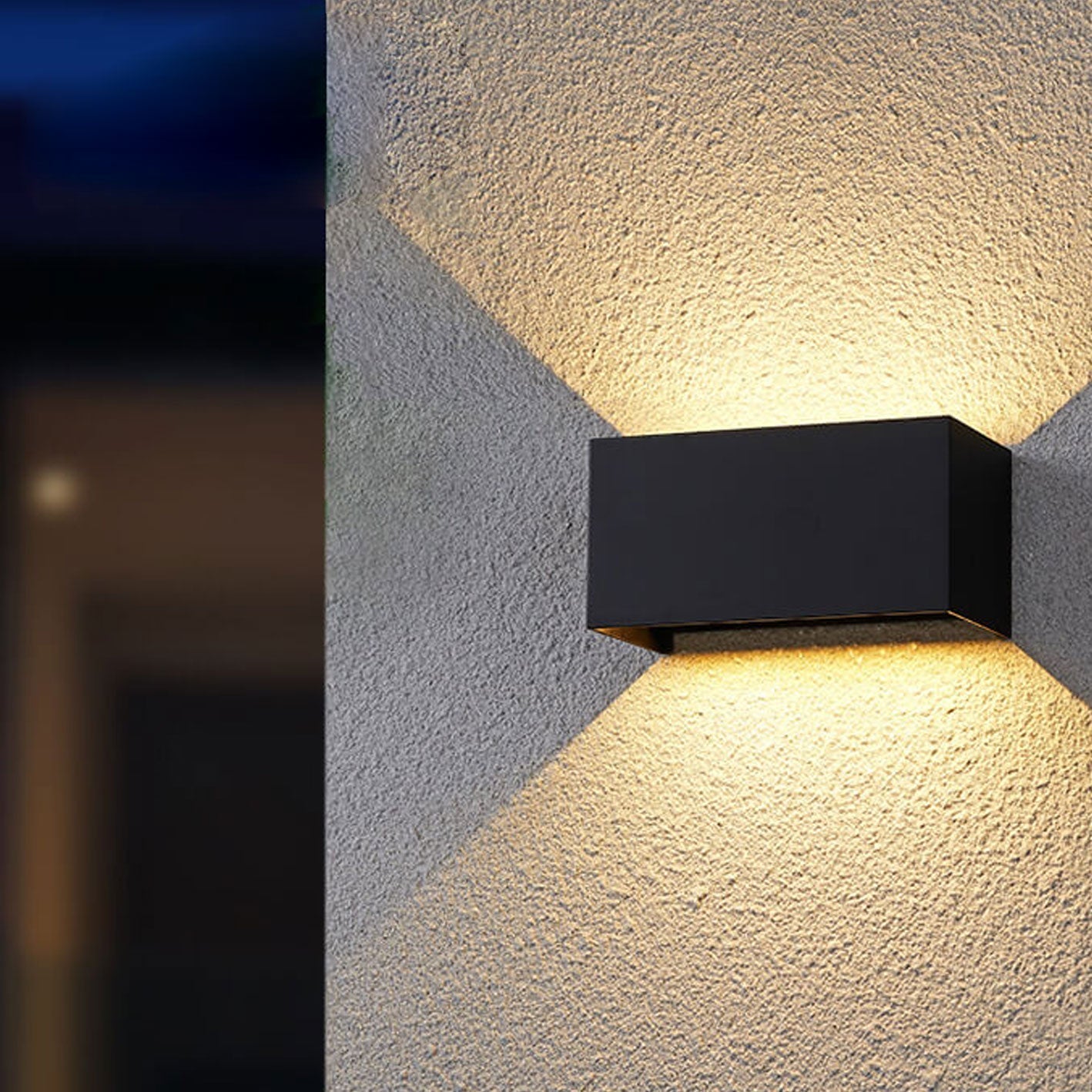 Modern, waterproof, rectangular outdoor LED wall light with up and down lighting.
