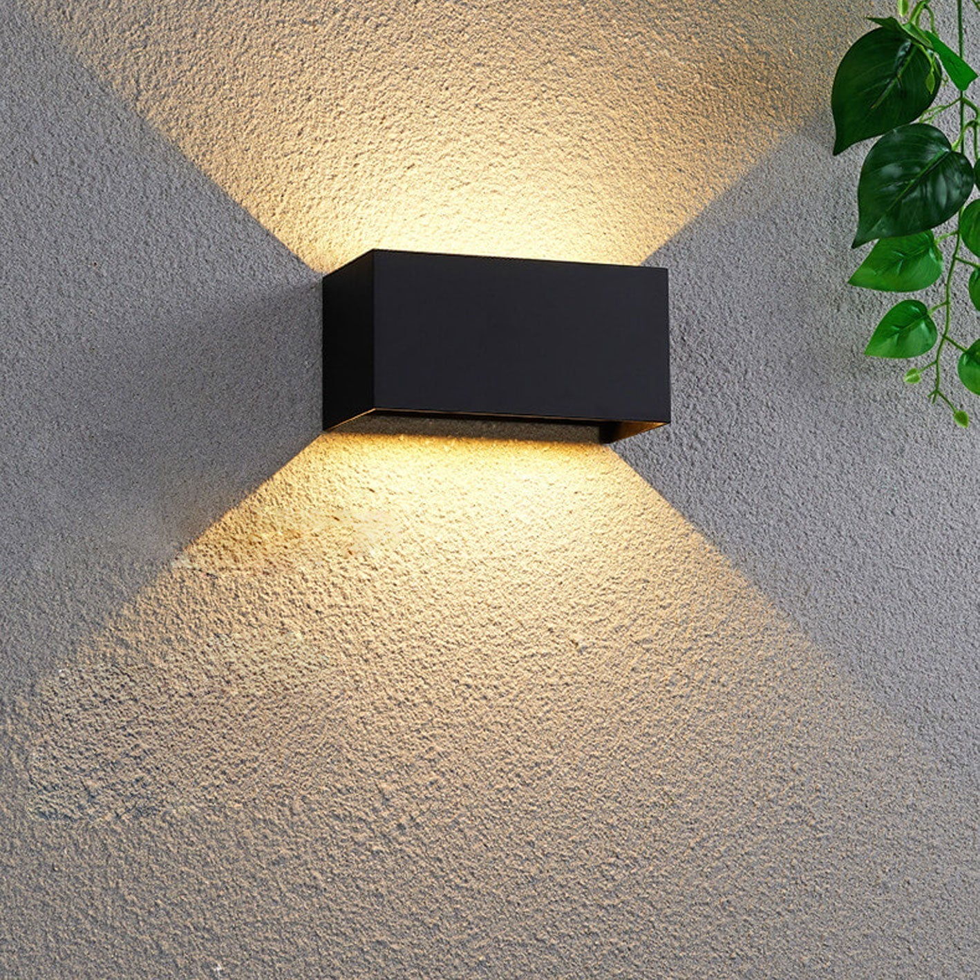 Modern, waterproof, rectangular outdoor LED wall light with up and down lighting.