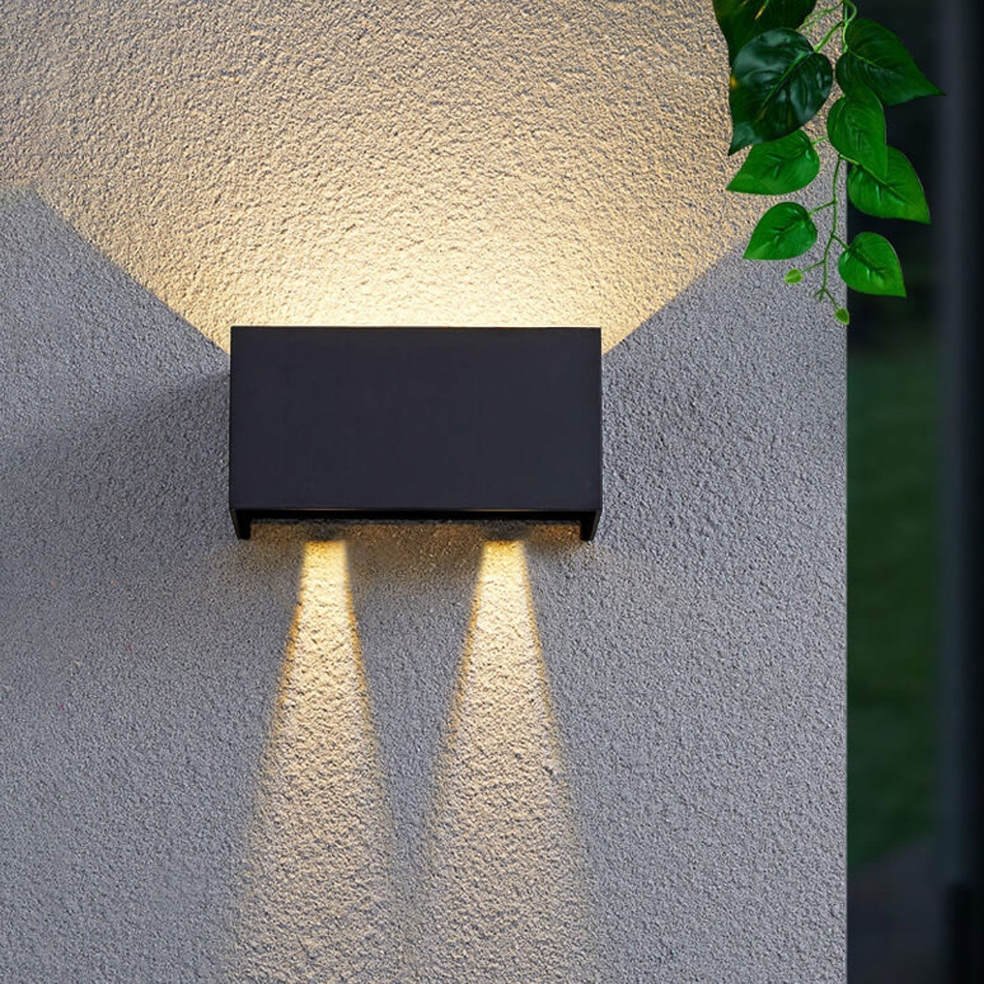 Modern, waterproof, rectangular outdoor LED wall light with up and down lighting.