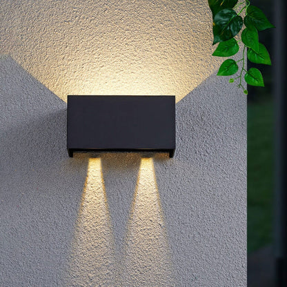 Modern, waterproof, rectangular outdoor LED wall light with up and down lighting.