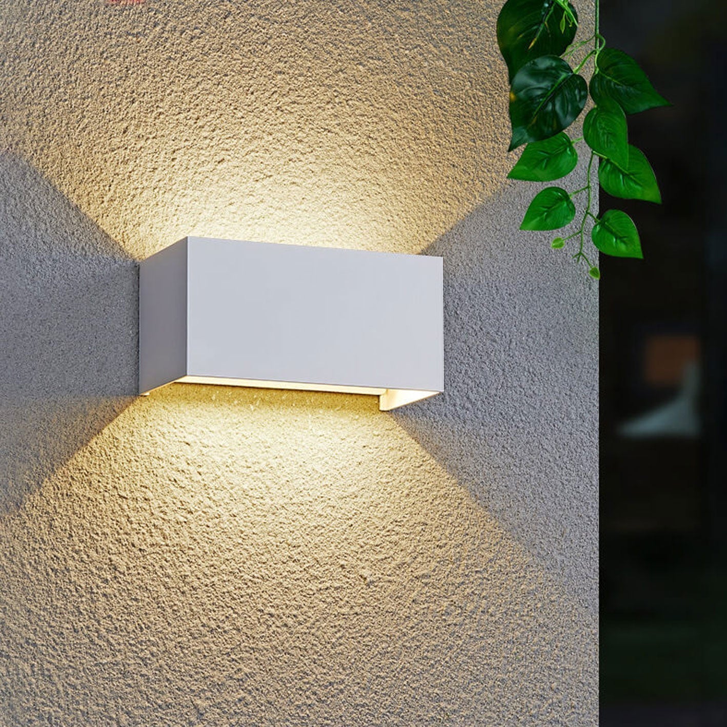 Modern, waterproof, rectangular outdoor LED wall light with up and down lighting.