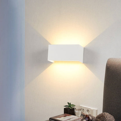 Modern, waterproof, rectangular outdoor LED wall light with up and down lighting.