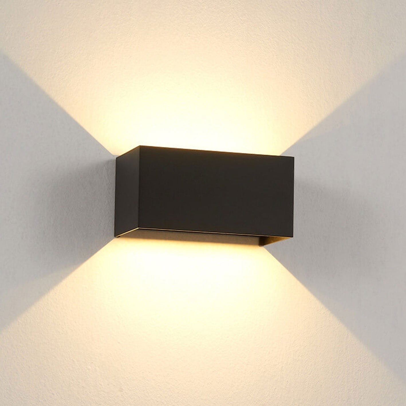 Modern, waterproof, rectangular outdoor LED wall light with up and down lighting.
