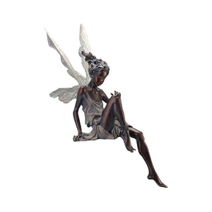 Statue of a sitting fairy in the garden