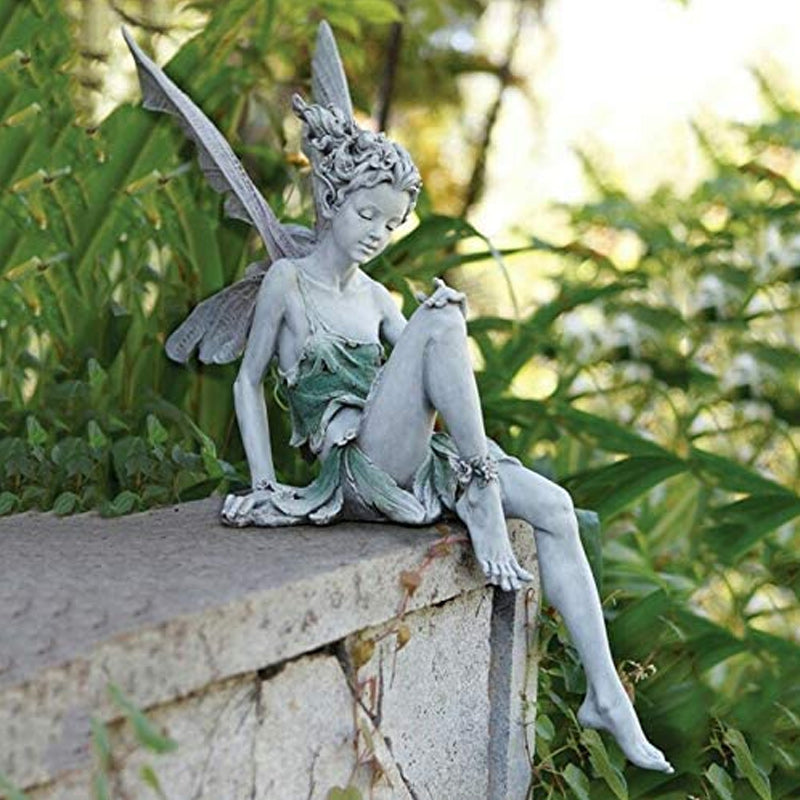Statue of a sitting fairy in the garden