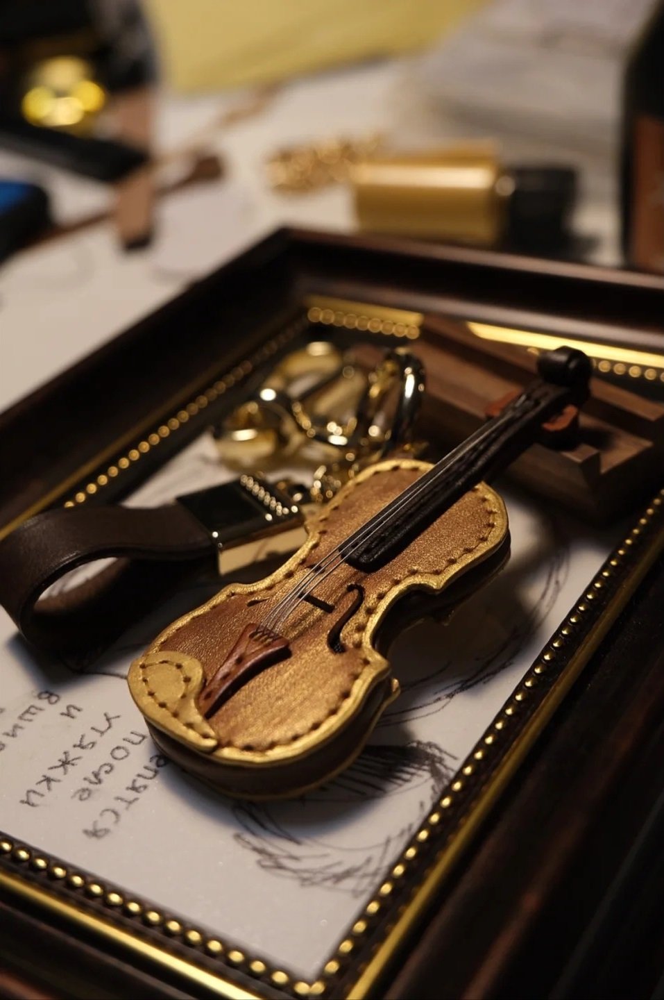 Crafted leather keychain with violin and cello