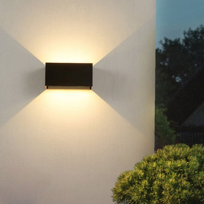 Modern, waterproof, rectangular outdoor LED wall light with up and down lighting.