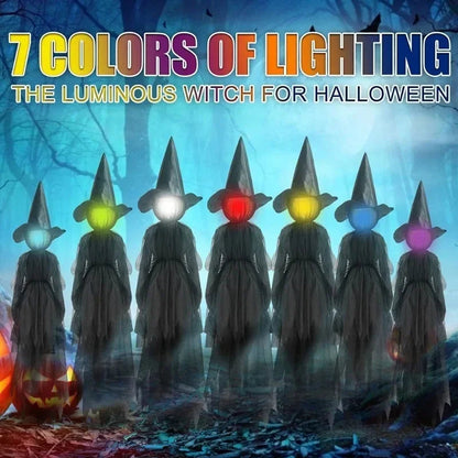 Glowing hand holds Halloween witch decoration