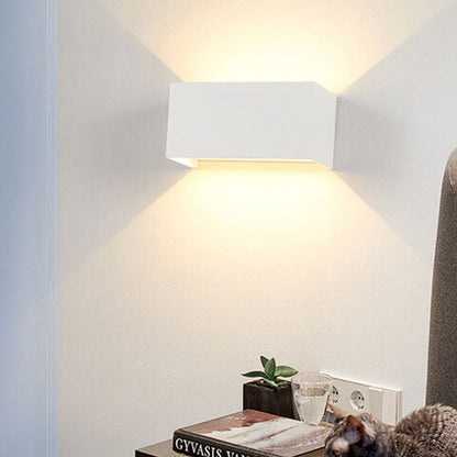 Modern, waterproof, rectangular outdoor LED wall light with up and down lighting.