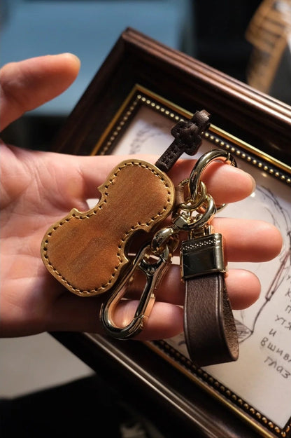 Crafted leather keychain with violin and cello