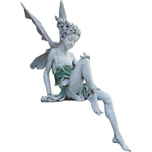 Statue of a sitting fairy in the garden
