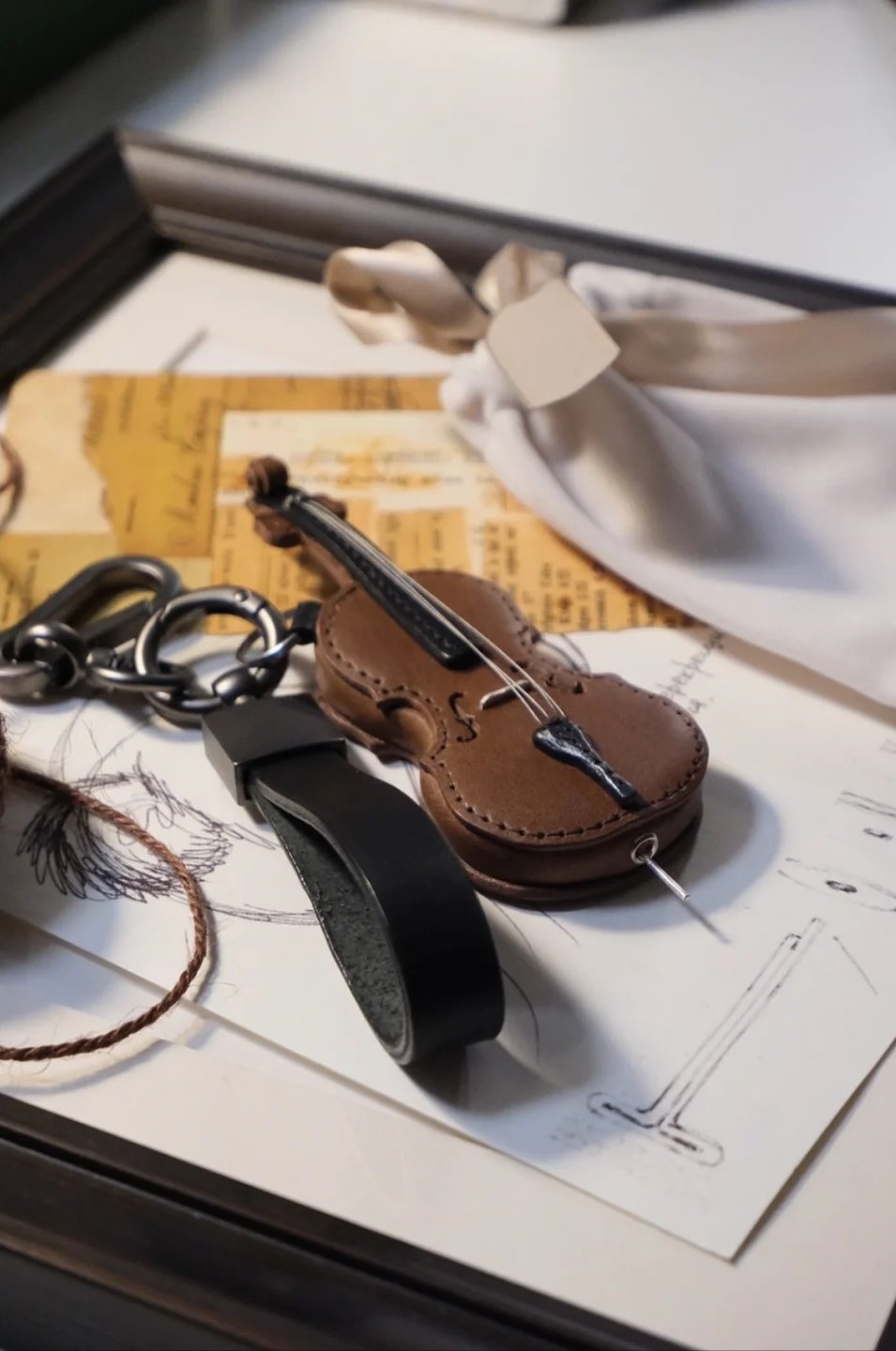 Crafted leather keychain with violin and cello