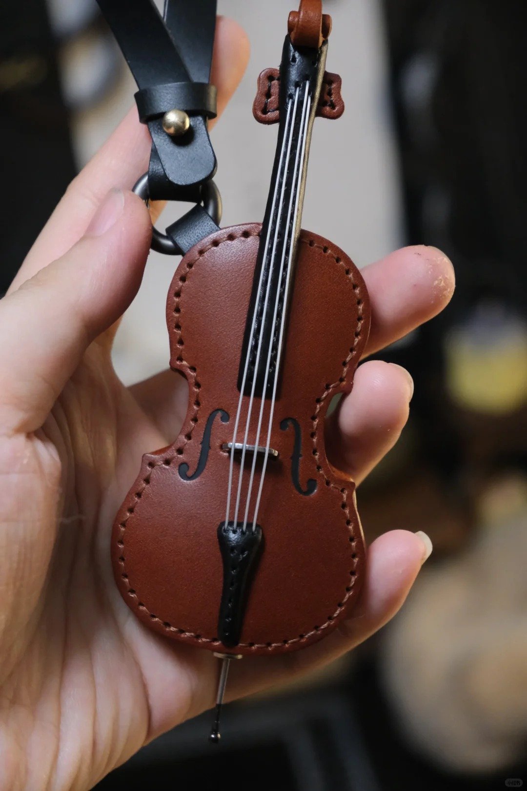 Crafted leather keychain with violin and cello