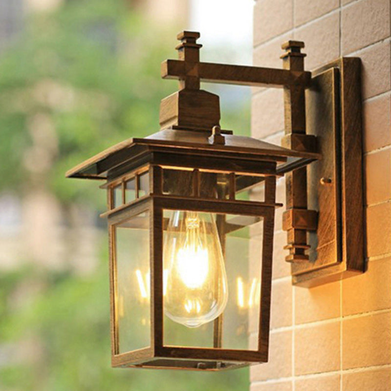 Traditional, rustic, rectangular wall lamp made of cast aluminum, iron, and glass with one light source for garden and patio
