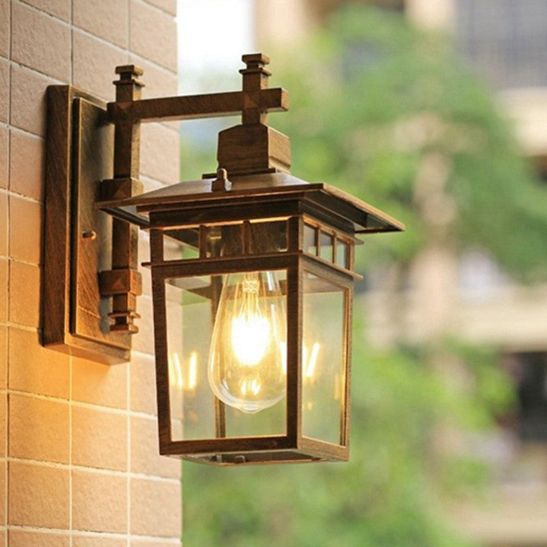 Traditional, rustic, rectangular wall lamp made of cast aluminum, iron, and glass with one light source for garden and patio