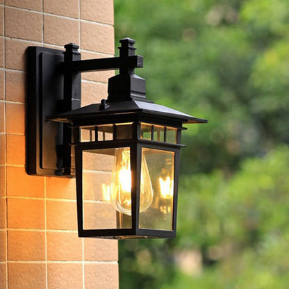 Traditional, rustic, rectangular wall lamp made of cast aluminum, iron, and glass with one light source for garden and patio