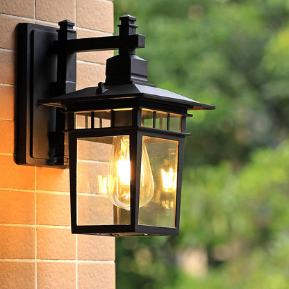Traditional, rustic, rectangular wall lamp made of cast aluminum, iron, and glass with one light source for garden and patio