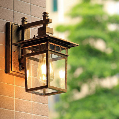 Traditional, rustic, rectangular wall lamp made of cast aluminum, iron, and glass with one light source for garden and patio