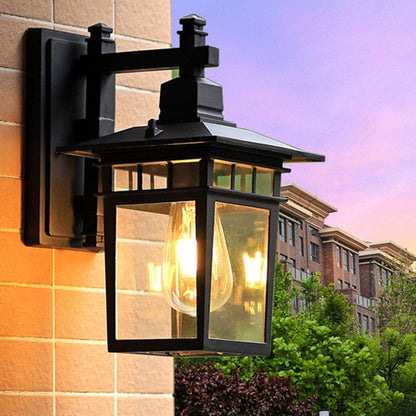 Traditional, rustic, rectangular wall lamp made of cast aluminum, iron, and glass with one light source for garden and patio