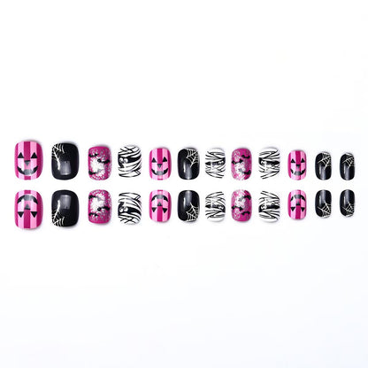 Creative nail art set with Halloween motifs and glitter accents Acalora