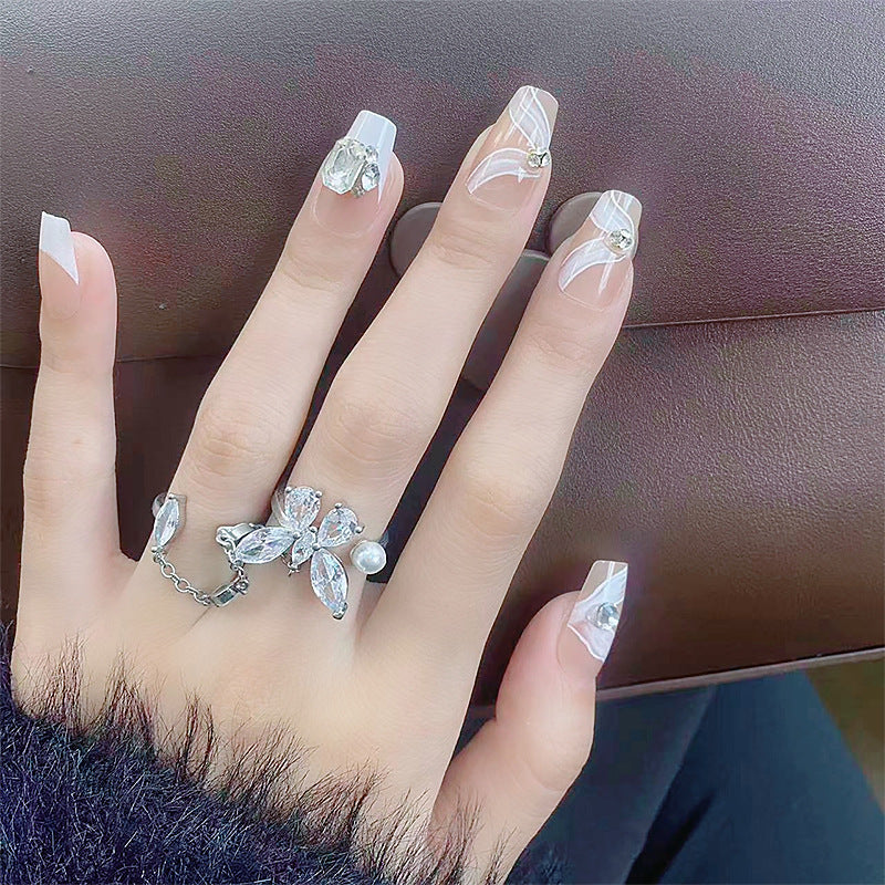 Elegant artificial nail set with delicate decorations and glitter elements Acalora