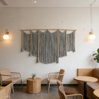 Macramé wall hanging with intricate fringes and wooden beads