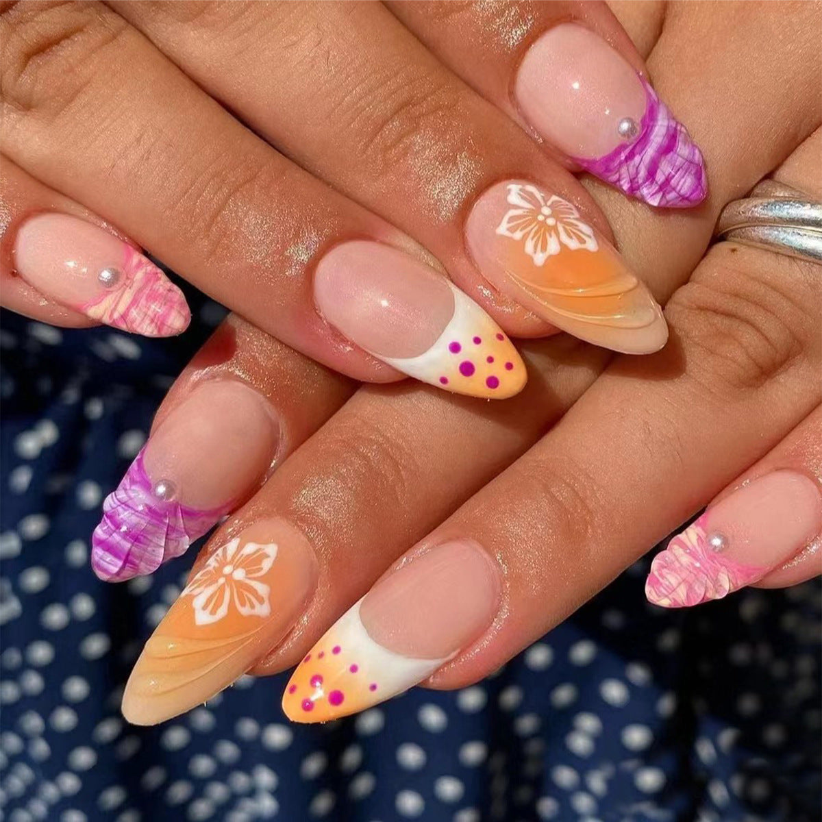 Acrylic nail set with exotic flower patterns and glitter accents Acalora