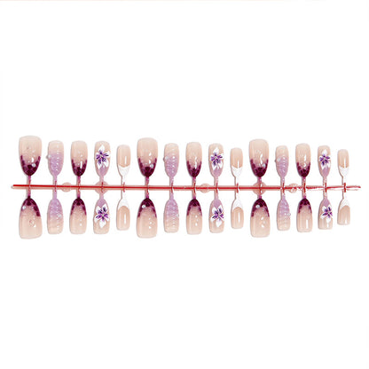 Artificial nail set with elegant ombre design and floral accents Acalora