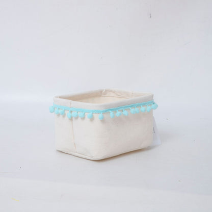 Storage basket with decorative pom-pom trim
