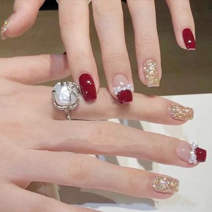 Glamorous artificial nails with glitter and pearl decorations Acalora