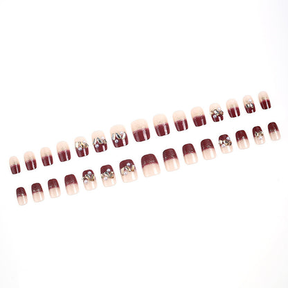 Glamorous artificial nails with decorative pearl and glitter embellishments Acalora