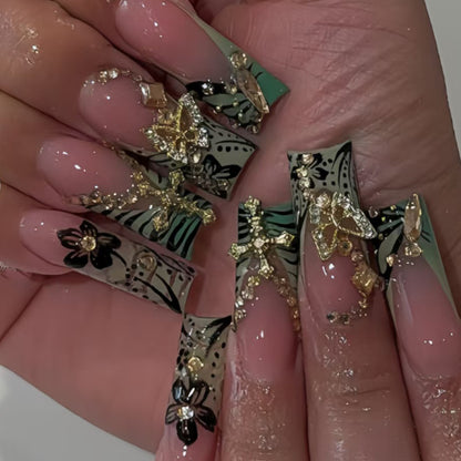 Artistic Stiletto Nail Design with Floral Accents and Gems Acalora
