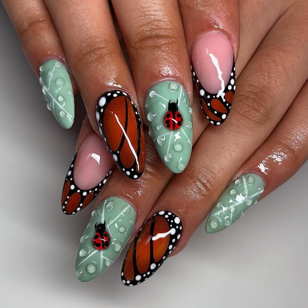 Creative nail art with elaborate butterfly and flower designs Acalora