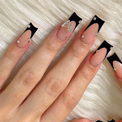 Acrylic nail set with elegant black and white design and glitter accents Acalora
