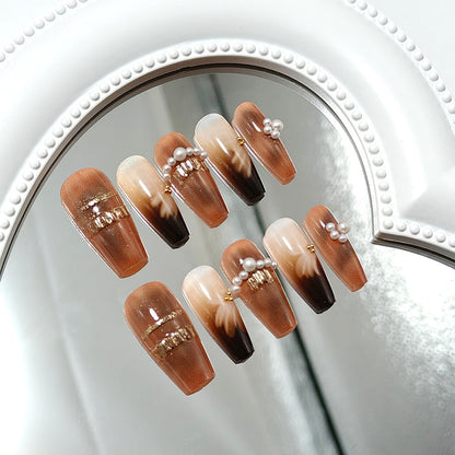 Artificial nails with glamorous gold and pearl embellished accents Acalora