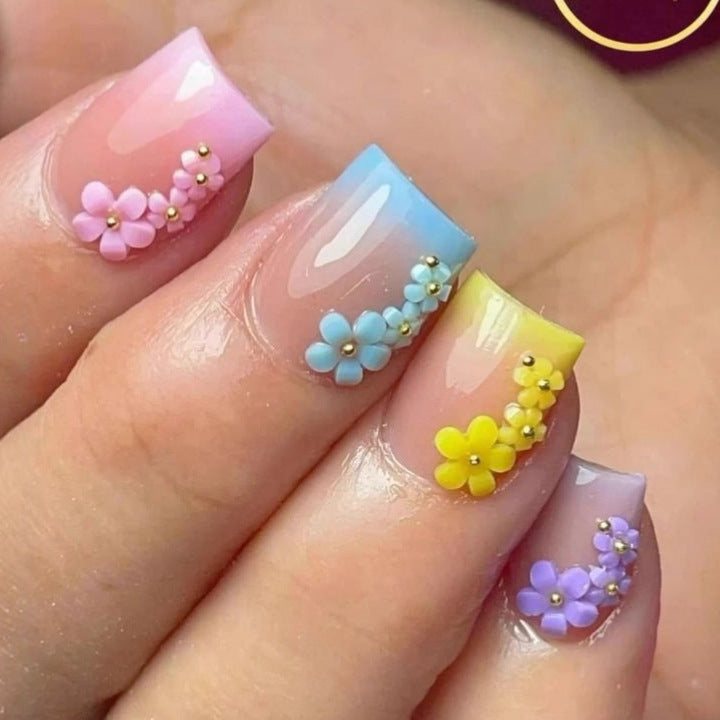 Artificial nails in a playful flower design with glittering accents Acalora