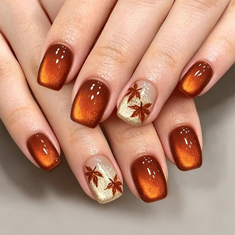 Artificial nails with glamorous ombre design and autumn leaf applications Acalora