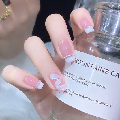 Elegant artificial nail set with stylish wave pattern and pearl accents Acalora