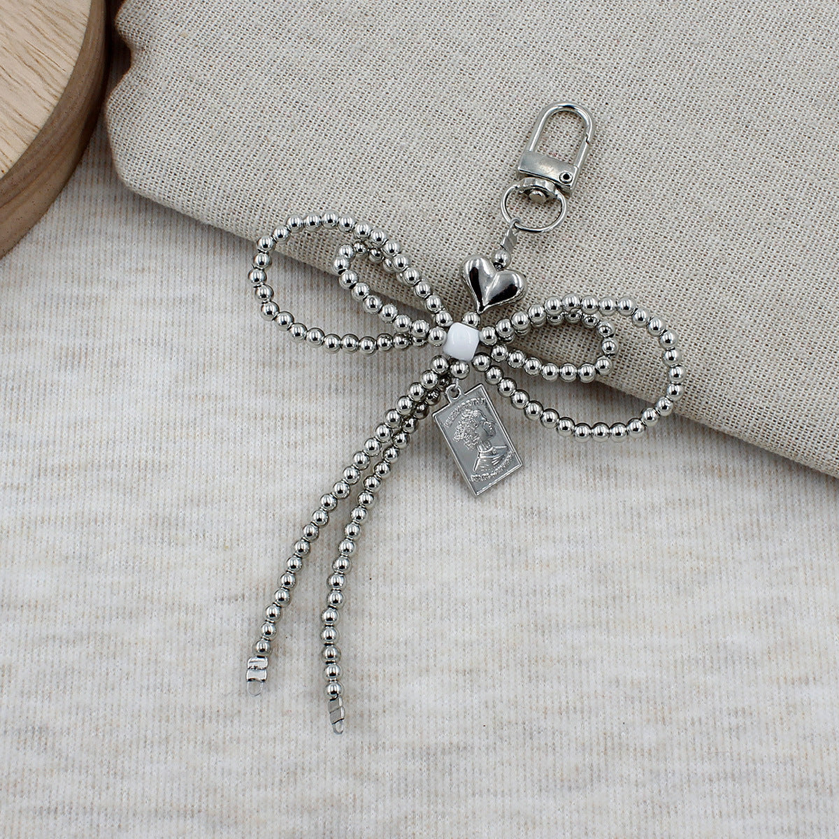 Elegant Beaded Bow Brooch Acalora