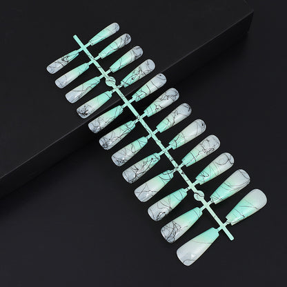 Artificial nails in modern ombre design with marbled accents Acalora