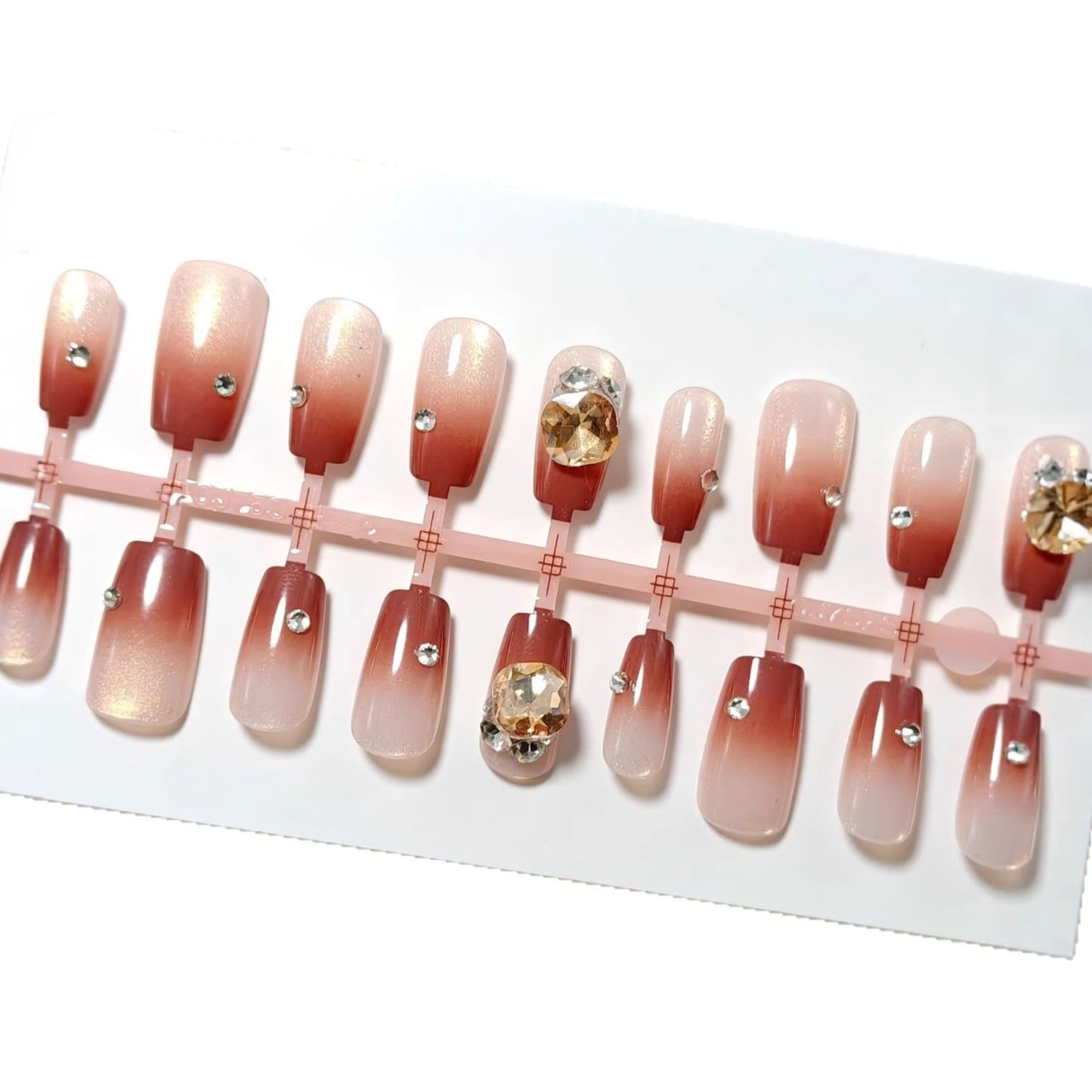 Artificials nails in elegant ombre style with rhinestone embellished applications Acalora