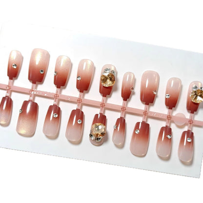 Artificials nails in elegant ombre style with rhinestone embellished applications Acalora