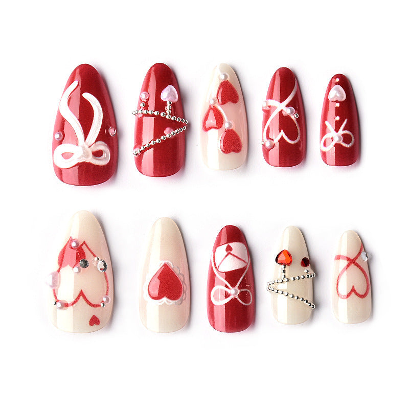 Glamorous artificial nail set with romantic heart design and elegant embellishments Acalora